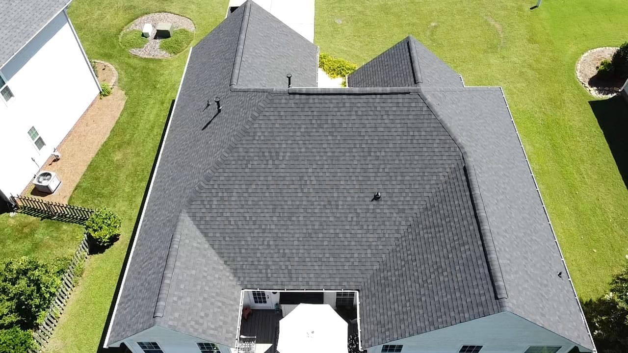 Aerial view of a completed gray architectural shingle roof